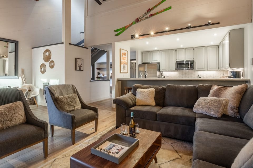 Sink into plush sofas and unwind in your stylish open-concept living space, where warm textures and mountain charm create the perfect après-ski retreat.