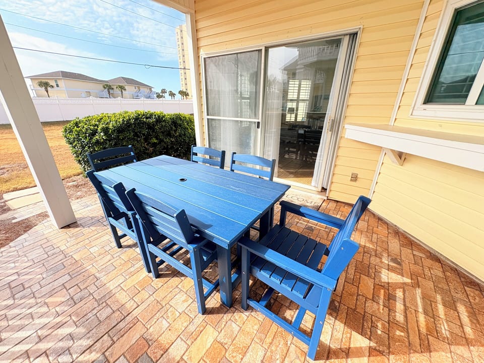 Step outside to your private patio where morning coffee tastes better at this inviting dining set, perfectly positioned for peaceful outdoor meals.