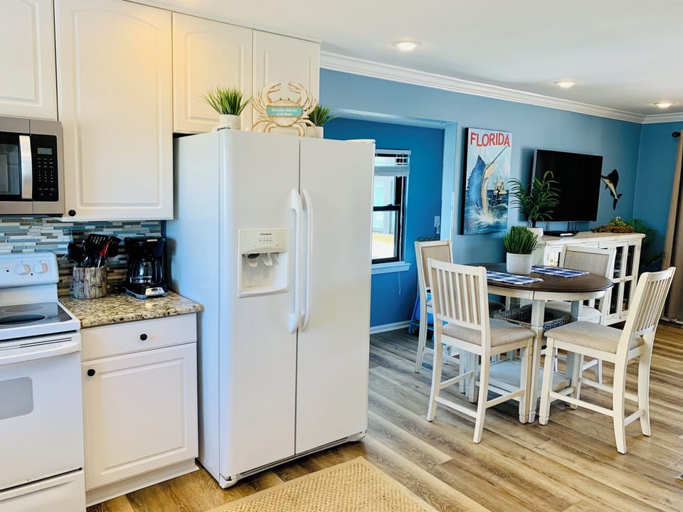 Step into your bright coastal kitchen where ocean-inspired blues meet crisp whites, creating the perfect space to prepare meals and gather.