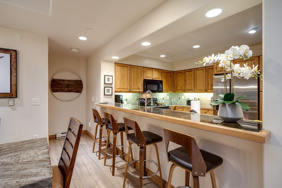 Your open kitchen invites culinary adventures with granite counters, modern appliances, and a welcoming breakfast bar perfect for morning coffee.