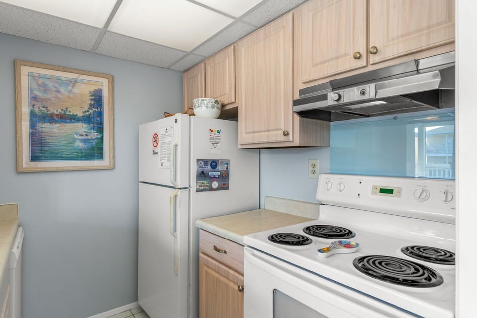 Your fully equipped kitchen has everything you need to whip up a meal. Light wood cabinets, a full-sized fridge, and an electric stove make cooking feel easy and comfortable.