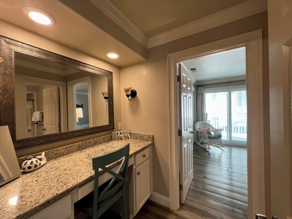 Freshen up at your elegant vanity with granite counters and warm lighting before stepping into your comfortable living space.