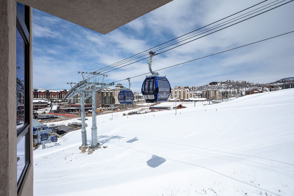 Property location near ski gondola with mountain village views and winter access to slopes.