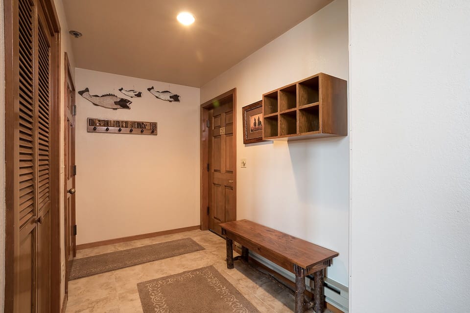 Your private entryway welcomes you with warm wood tones, organized storage cubbies, and a cozy bench for settling in.