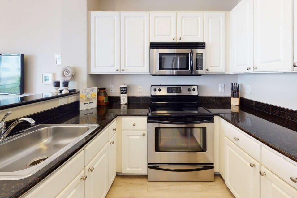 Fully equipped kitchen with granite counter-tops and stainless appliances