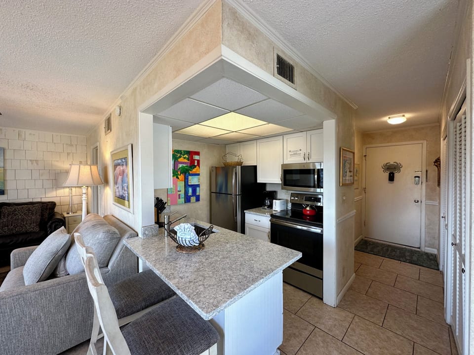 Your open-plan living space features a modern granite island perfect for morning coffee and casual dining.
