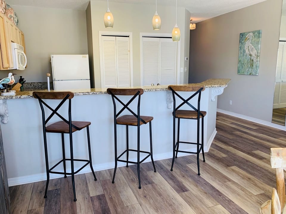 Your open kitchen breakfast bar creates the perfect spot for morning coffee or casual meals together.