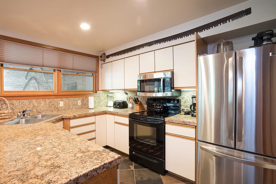Your fully equipped kitchen features granite countertops, stainless steel appliances, and everything you need to create memorable meals during your stay.