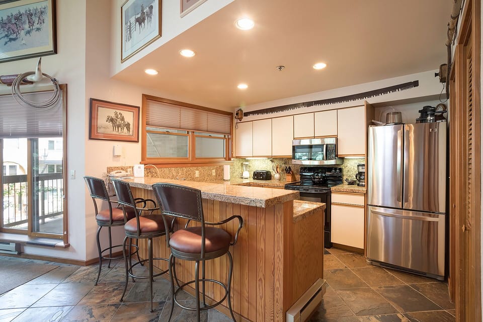 Gather around your spacious granite island kitchen, featuring stainless steel appliances and warm wood cabinetry for memorable cooking moments.