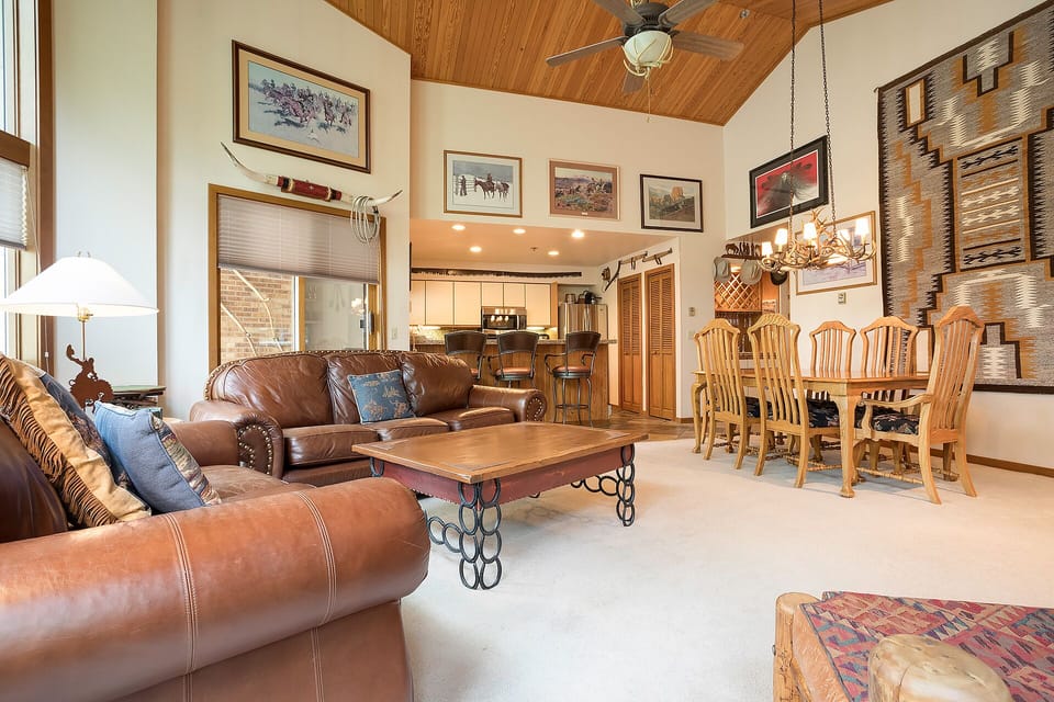 Relax in your spacious living area with rich leather seating, rustic charm, and a fully equipped kitchen ready for your mountain getaway.