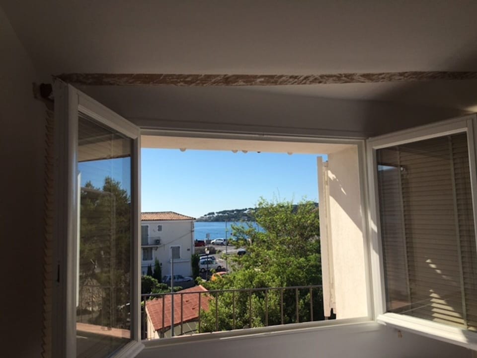 Lie in bed and look across the square to the sea. Easier in winter fewer leaves!