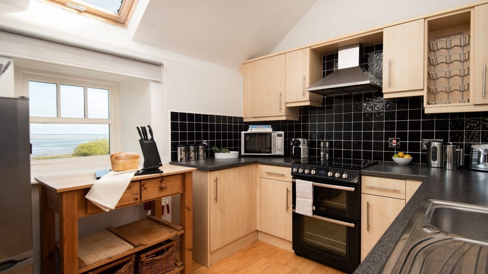 Budle Bay Loft - kitchen area with sea views