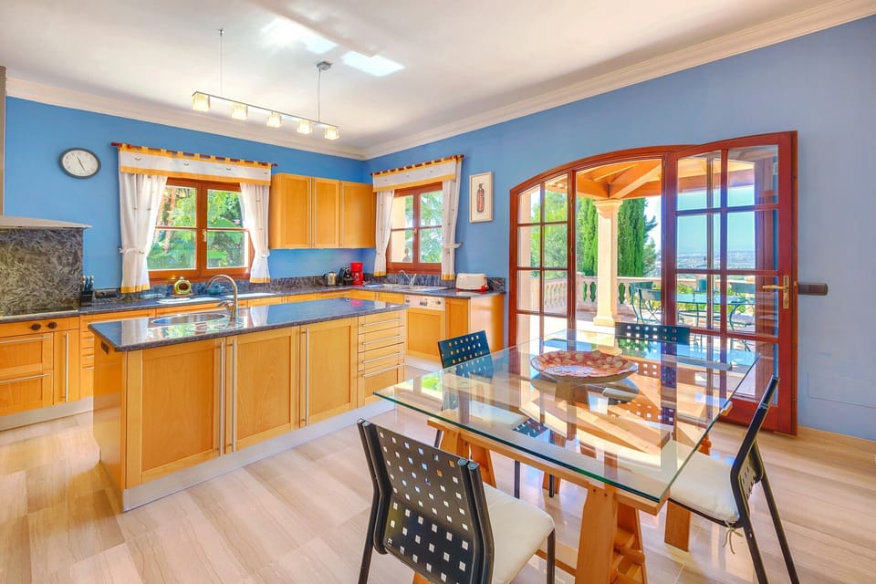Kitchen-dining area with access to the terrace and views of the island's mountains