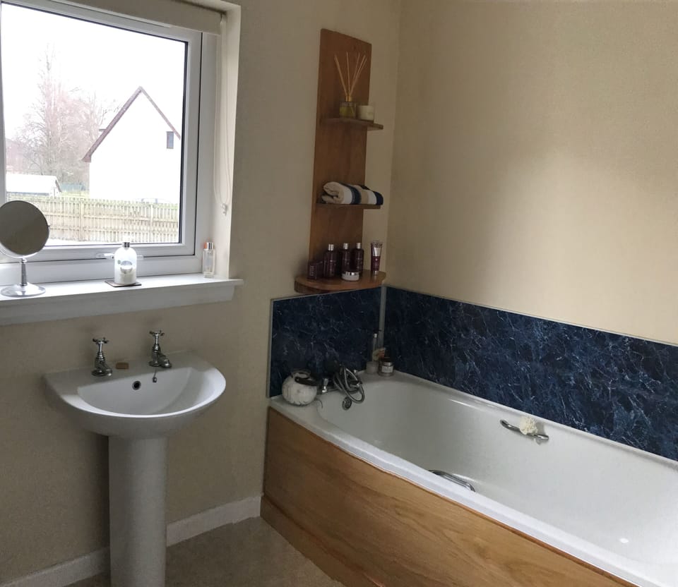 Spacious bathroom with bath and separate shower cubicle
