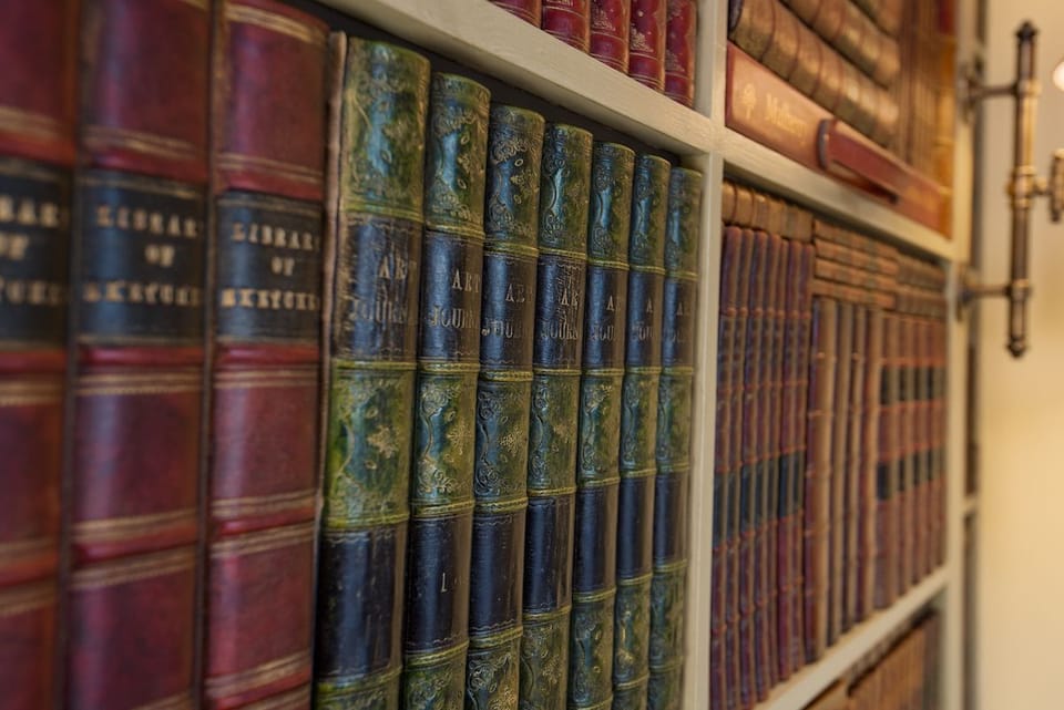 The Cottage - bedroom two with book panelled wall