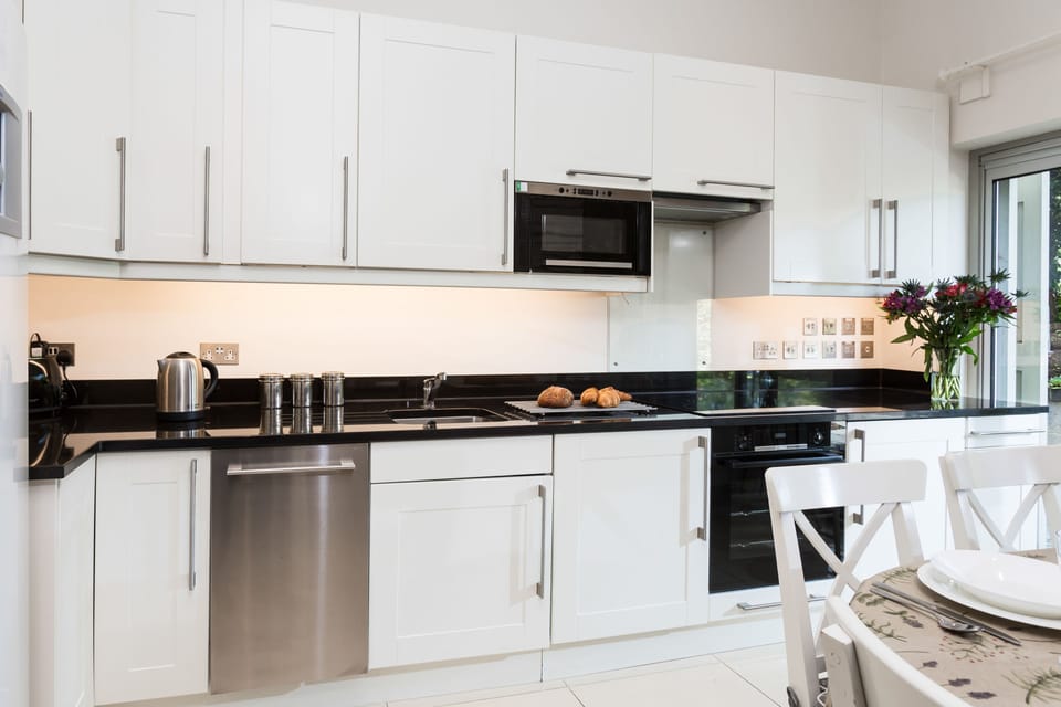 Well-equipped kitchen with an electric oven and hob and sliding door leading to the patio