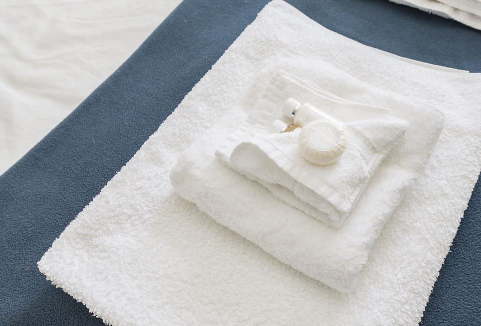 Fluffy towels and complimentary toiletries await