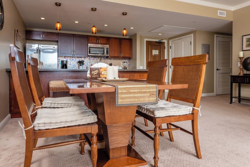 Stylish dining and kitchen area with pendant lights and island vibes.