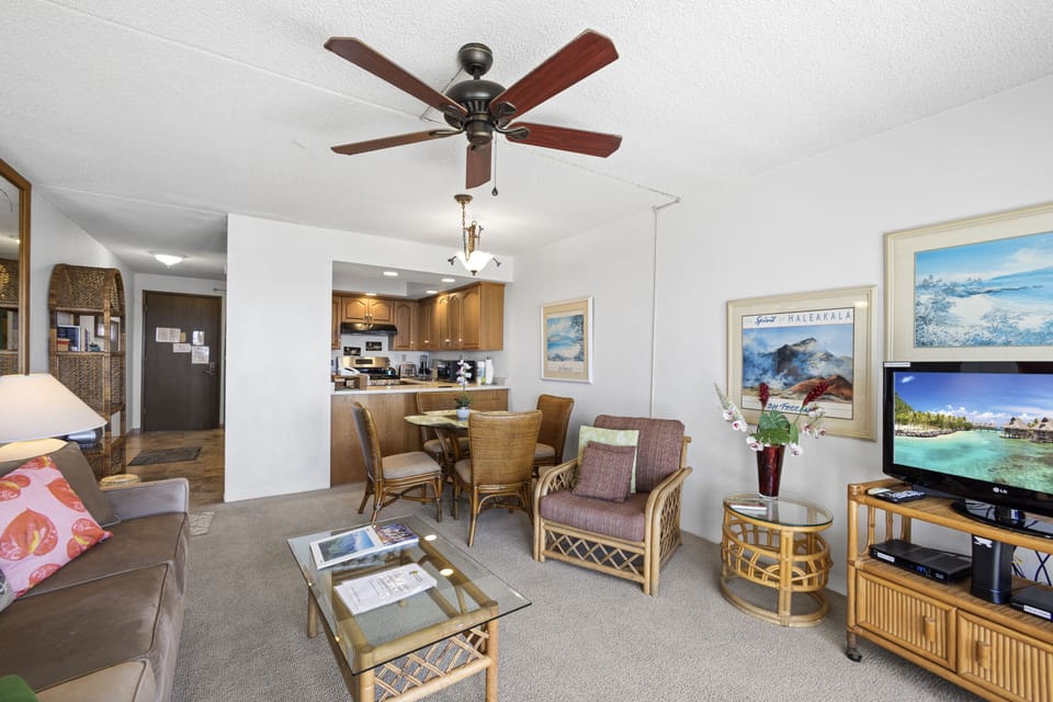 Step into your open-plan living space where coastal charm meets comfort. Relax under the ceiling fan, unwind with entertainment, and enjoy seamless access to your dining area and kitchen.