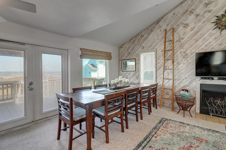 Gather around your spacious dining table with rustic wood accents and coastal views through large windows.
