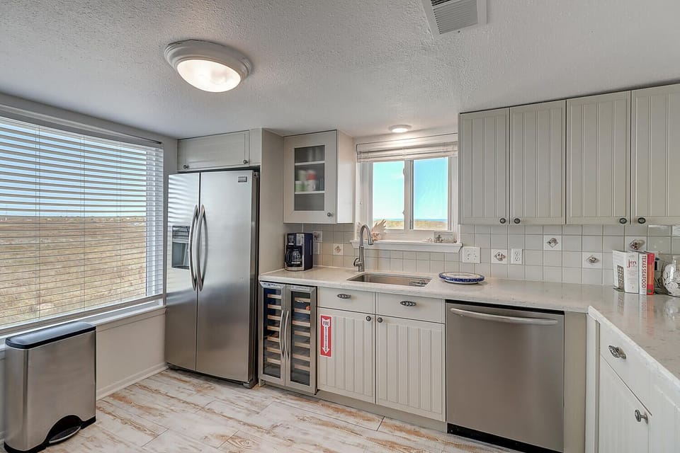 Your fully equipped kitchen features stainless steel appliances, wine storage, and plenty of prep space for creating memorable meals.