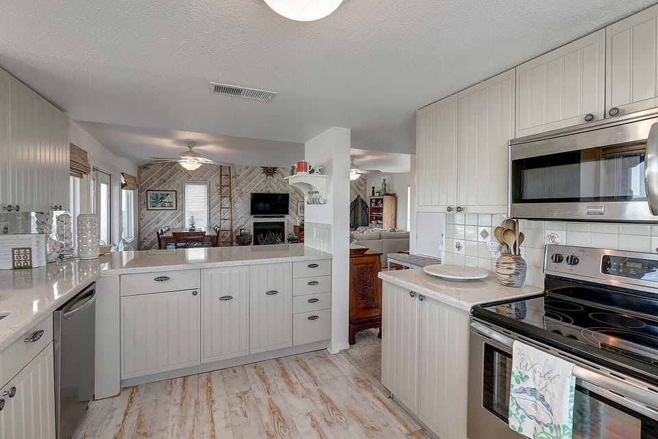 Your spacious kitchen invites culinary adventures with gleaming countertops, modern appliances, and a welcoming open layout that flows into the cozy living area.