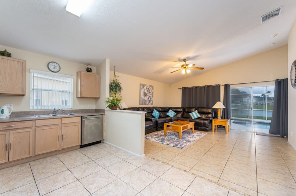 Bright open concept living space with comfortable seating, natural light, and direct access to the pool area, perfect for unwinding after a day of exploring.
