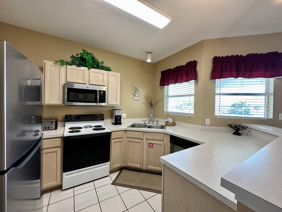 Your fully equipped kitchen features white appliances, ample counter space, and everything you need to prepare your favorite meals during your stay.
