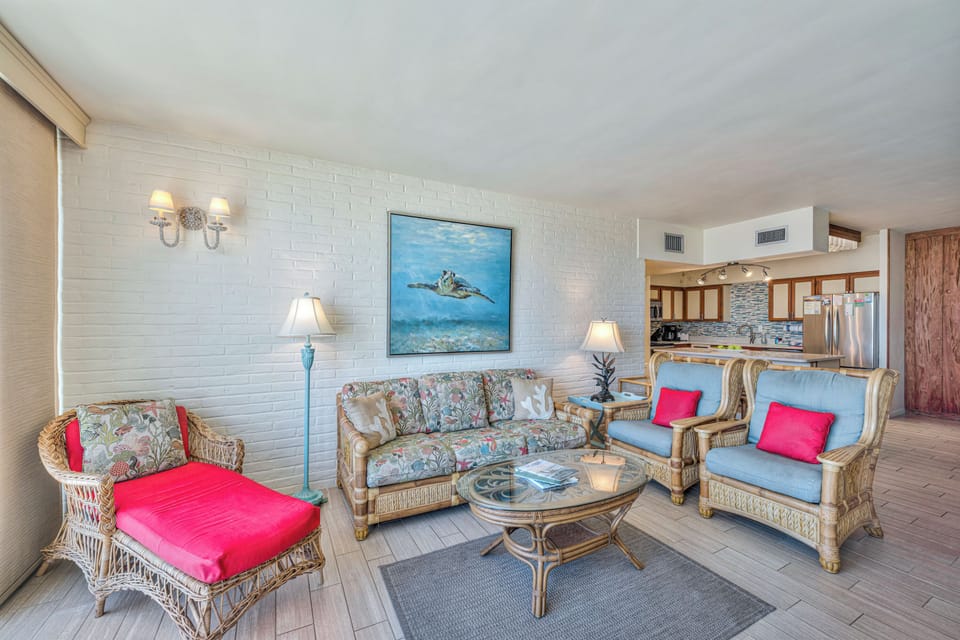 Sink into coastal elegance with wicker seating and ocean artwork creating your perfect beachside retreat.