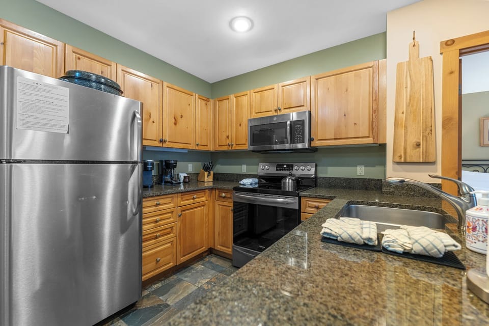 Full kitchen with stainless steel appliances and granite countertops