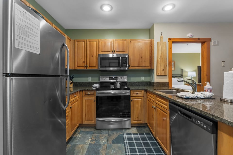 Full kitchen with stainless steel appliances and granite countertops