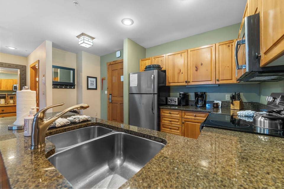 Full kitchen with stainless steel appliances and granite countertops