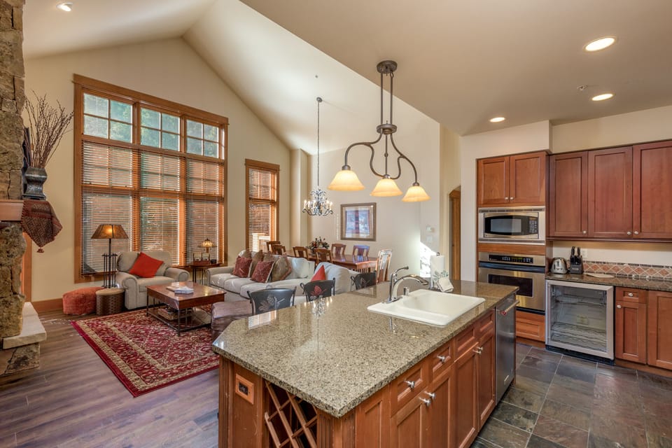 Your spacious open-plan living space flows seamlessly from kitchen to cozy seating area, perfect for gathering with loved ones.