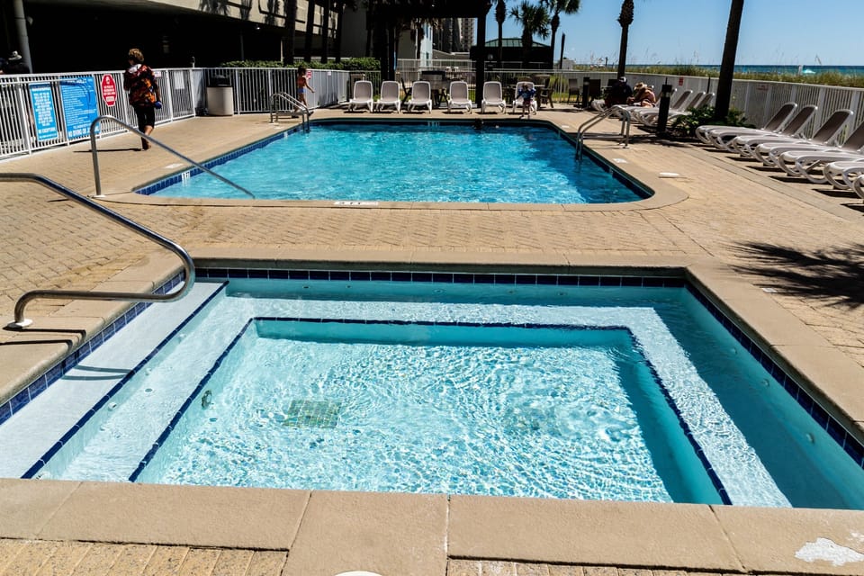 Two swimming pools and large hot tub summer or winter!      t tub area. Grill area at far end.
