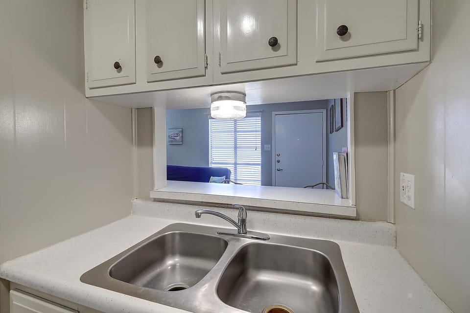 Your fully equipped kitchen features a spacious double sink and breakfast bar opening to your bright living area.