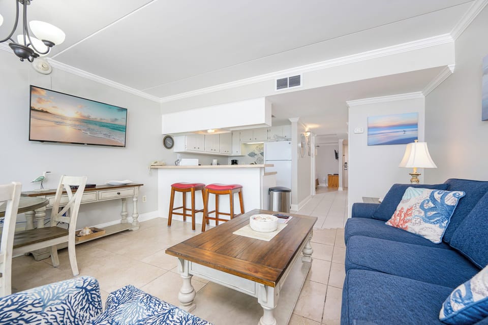 Unwind on the plush sofa with a queen sleeper, streaming your favorite shows while enjoying the inviting beach vibe