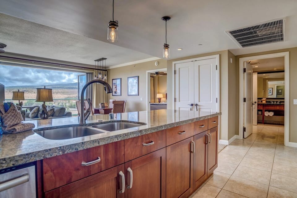 Granite kitchen island opens to mountain views and your luxury suite.