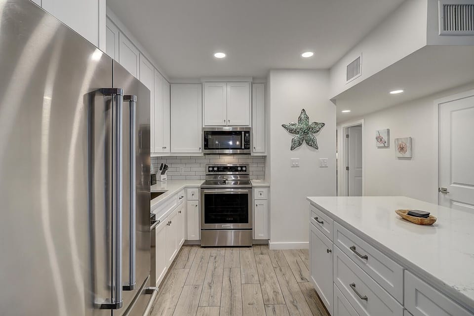 Your fully equipped kitchen features stainless steel appliances, quartz countertops, and everything you need to prepare memorable meals during your stay.