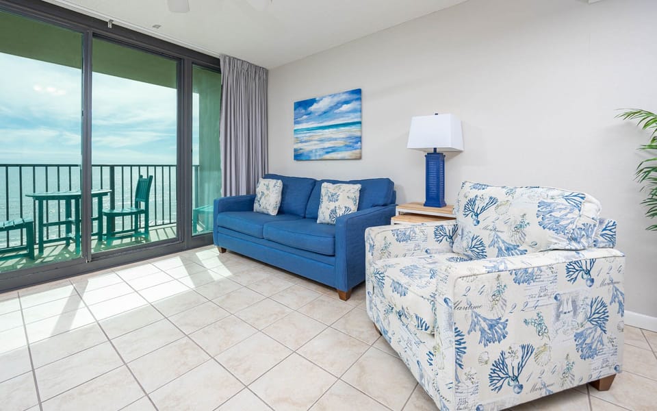 Unwind in the bright living area featuring a sofa with queen sleeper and a view that invites relaxation and tranquility