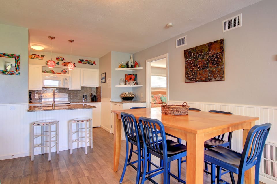 Gather around this inviting dining table where meals become memories, with a fully equipped kitchen ready for your culinary adventures.