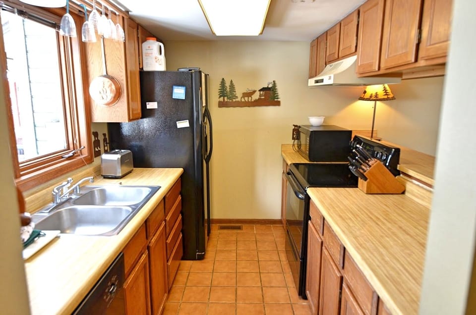 Fully Equipped Kitchen - Fully equipped kitchen next to an open dining room and living room area.