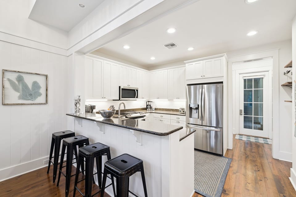 Your spacious kitchen features gleaming granite counters, stainless steel appliances, and a breakfast bar where you can enjoy morning coffee.