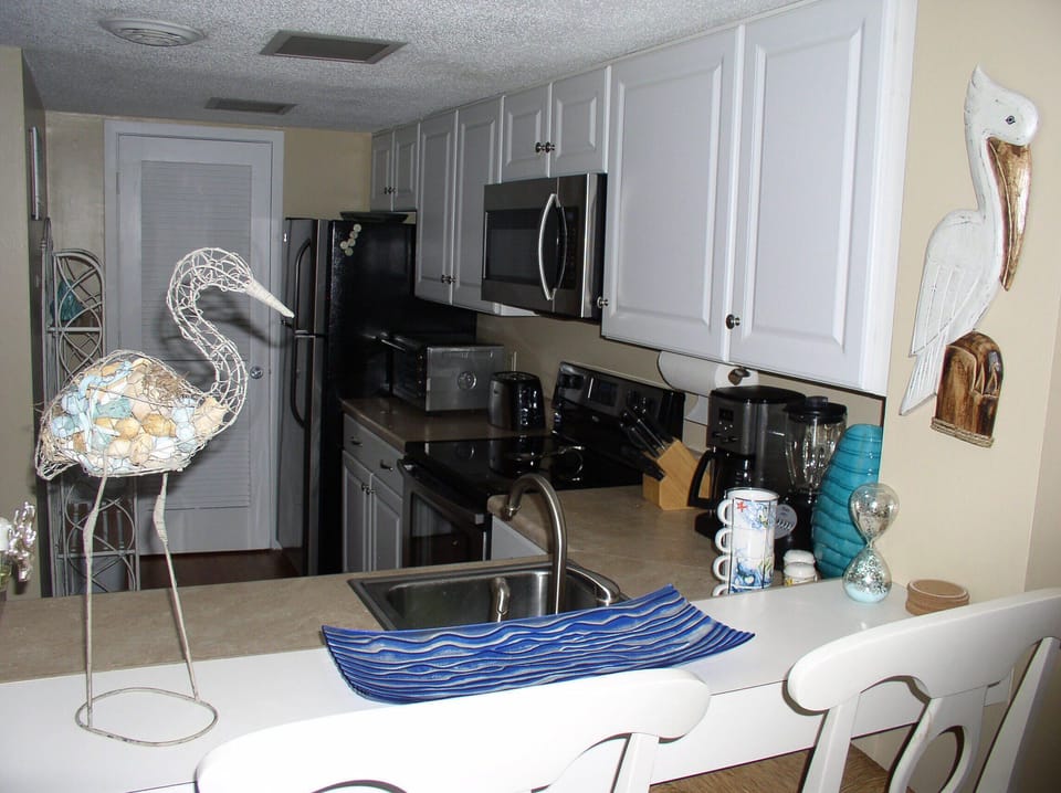 View of Kitchen from Living Room. (White chairs replaced 5/20)