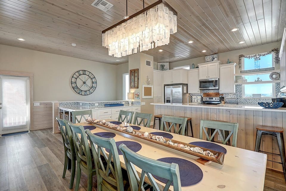 Gather your group around this stunning dining table beneath a gorgeous chandelier, with a fully equipped kitchen ready for your culinary adventures.