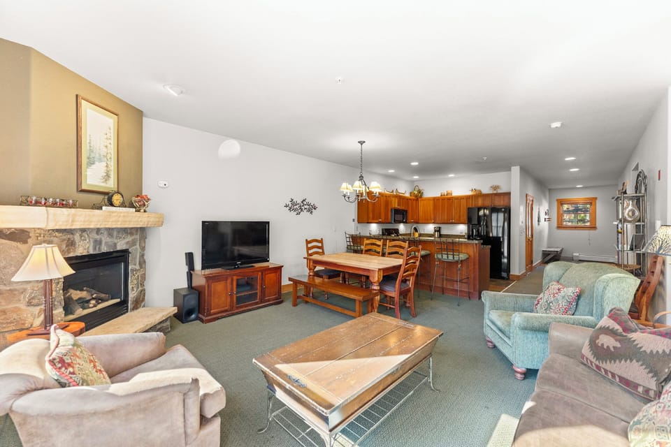 Relax in your spacious open-plan retreat with cozy fireplace, full kitchen, and mountain lodge charm perfect for group gatherings.