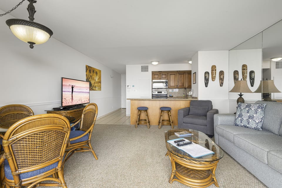 Your open-concept retreat combines a relaxing living space with tropical island decor, a cozy seating area, and a convenient breakfast bar perfect for morning coffee and casual conversations.