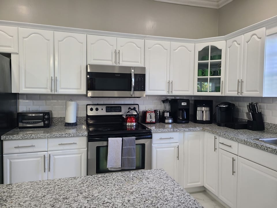 Fully equipped kitchen with all modern appliances and gadgets.