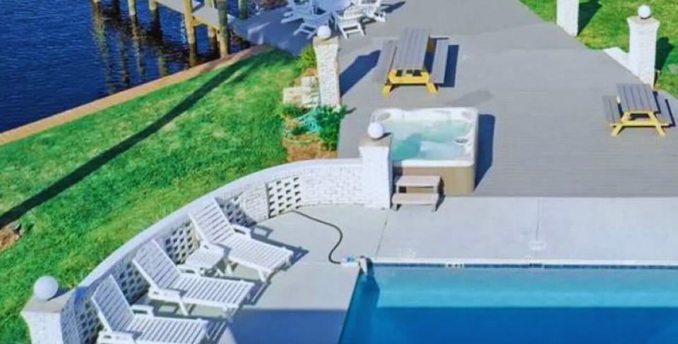Aerial view of Bay Shore featuring the pool, hot tub, and dockside lounge.