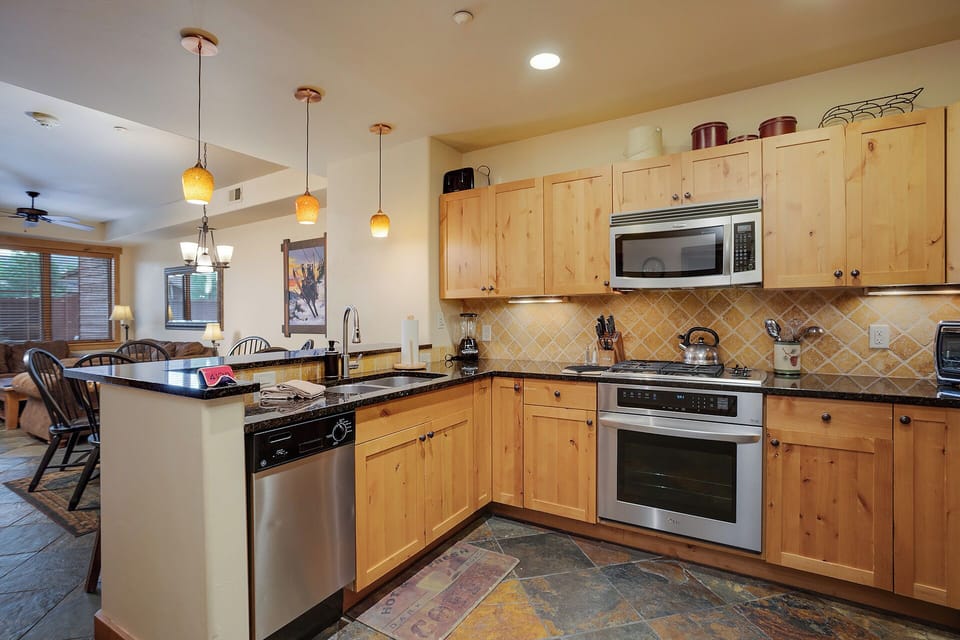 Your fully equipped kitchen features warm wood cabinetry, granite counters, and stainless appliances—perfect for preparing memorable meals together.