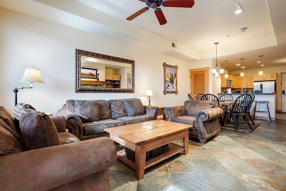 Sink into plush leather sofas in your spacious living room, where rustic charm meets modern comfort for perfect relaxation.